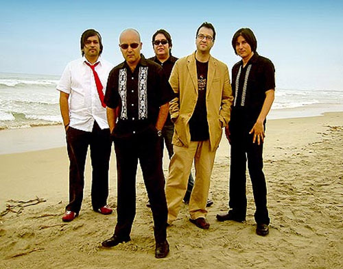 Members of the Nortec Collective stand at the beach