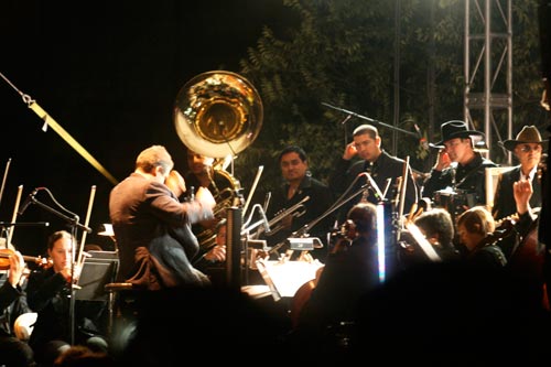 The conductor leads members of La Orquesta de Baja California in unison with the Nortec Collective's electronic beats.